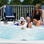 Family relaxing in a Vita Spa swim spa